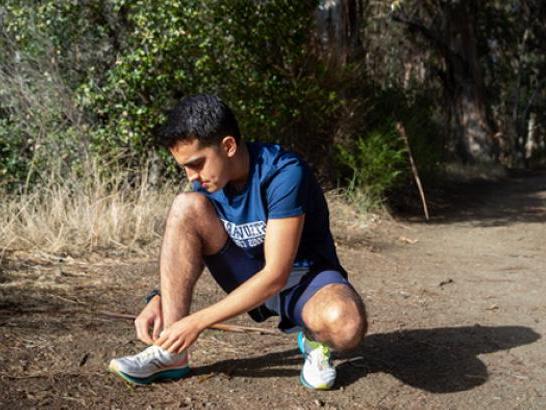 Cross Country athlete prepares for a trail run. 